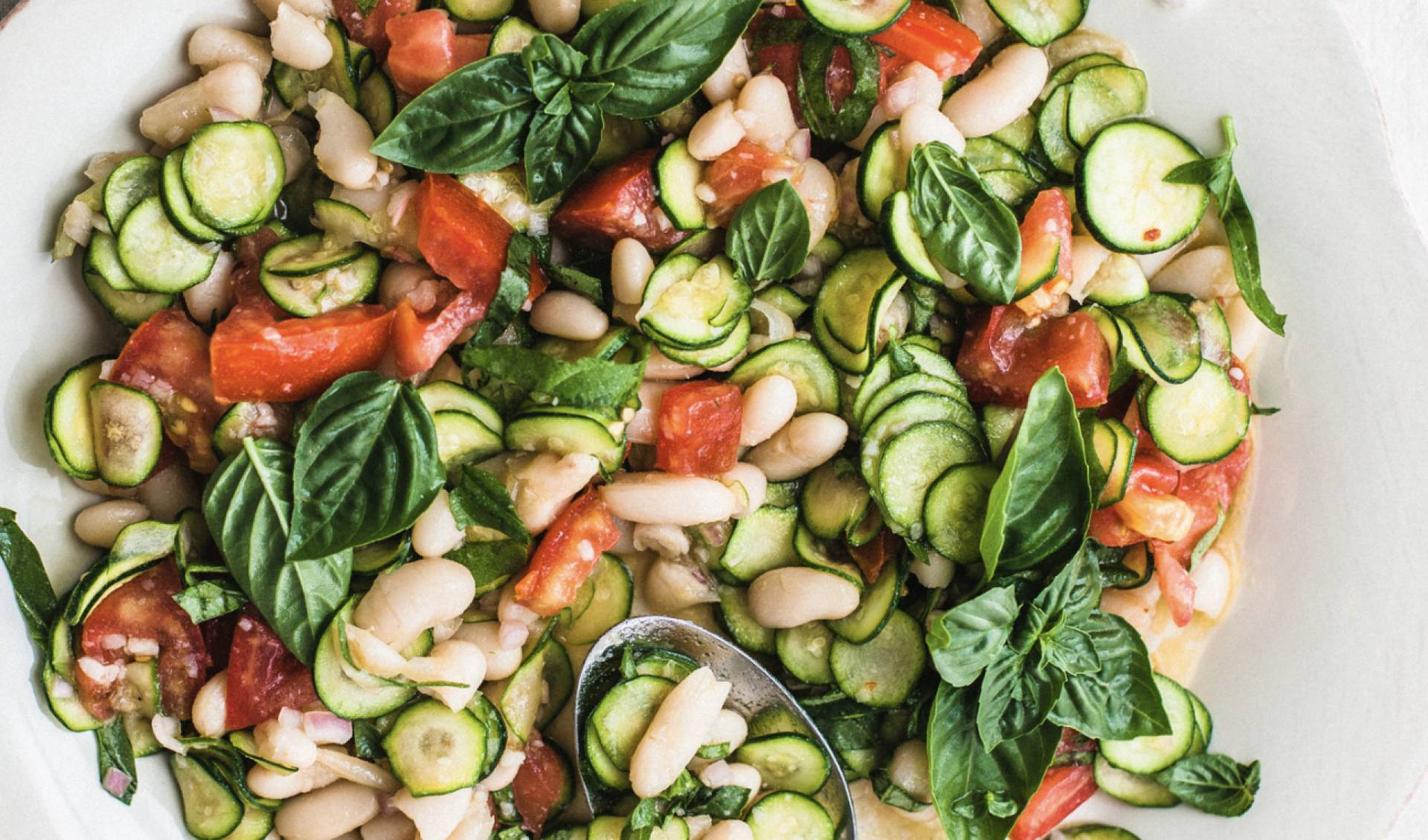 Protein Packed White Bean Herb Salad with Tomatoes, Parmesan, Peas, and Cucumbers with Basil Vinaigrette