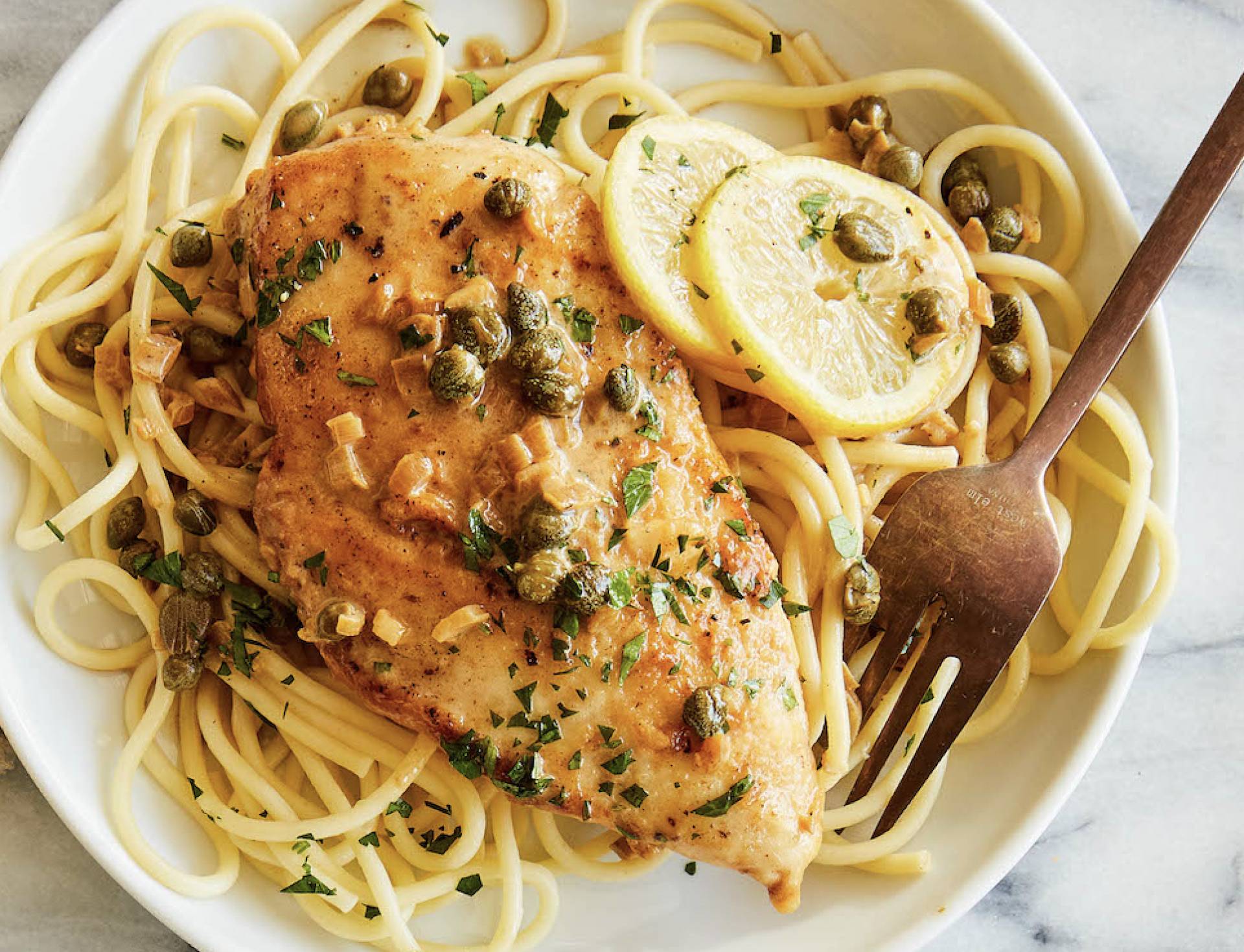 Grilled Lemon Chicken Piccata with Capers, Parsley, and Artichoke Hearts over Pasta (DF)